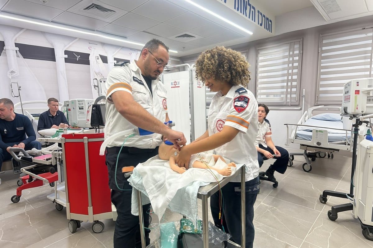 MDA paramedics practice neonatal resuscitation on an infant manikin in a simulation classroom