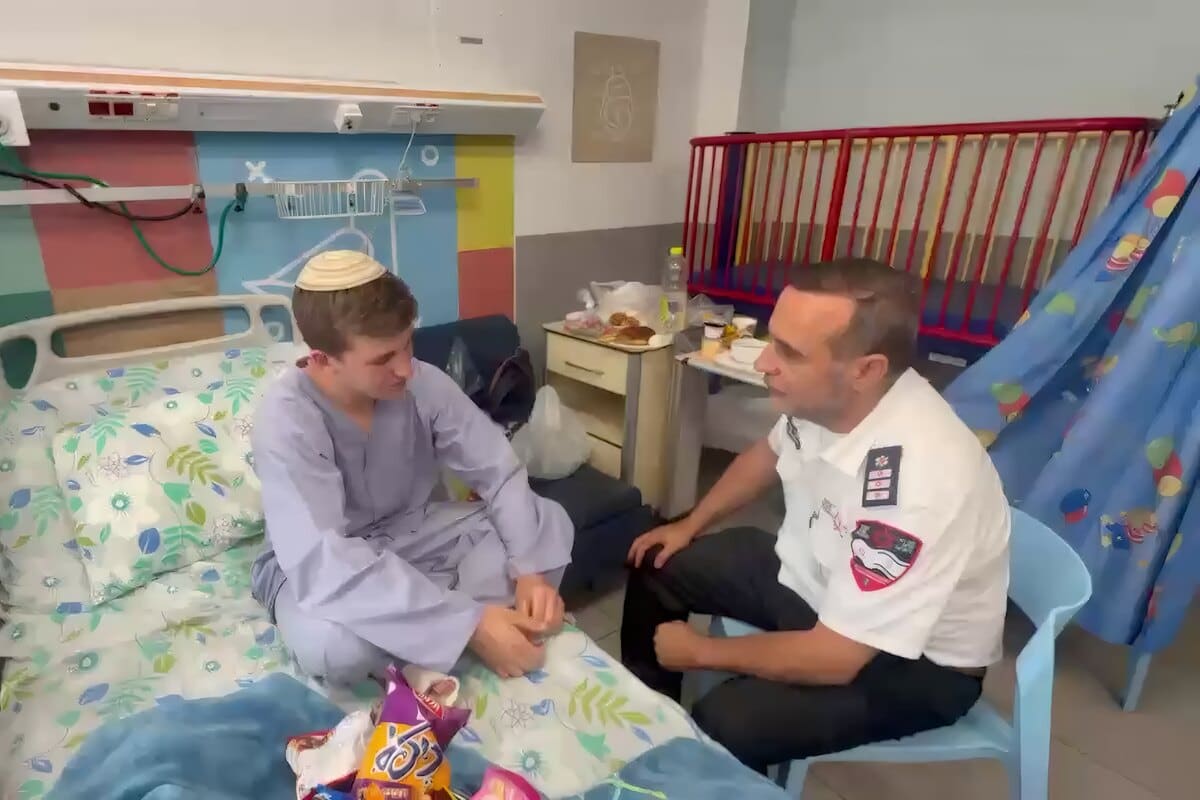 MDA youth volunteer Yair Frankenthal talks with an MDA paramedic from his hospital bed